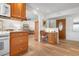 Open concept living space with wood cabinets, office desk, and comfortable seating arrangement at 9527 Azure Cv, Bradenton, FL 34210