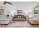 Comfortable living room with hardwood floors, stylish seating, and ample natural light, creating a welcoming atmosphere at 9527 Azure Cv, Bradenton, FL 34210