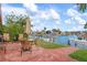 Outdoor patio furniture with view of the canal, boat dock and boat lift at 9527 Azure Cv, Bradenton, FL 34210