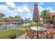 Back patio with wicker furniture, and canal with boat dock and boat lift at 9527 Azure Cv, Bradenton, FL 34210