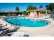 Community outdoor swimming pool and lounge chairs on a sunny day at 9527 Azure Cv, Bradenton, FL 34210