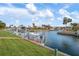View of waterfront properties with boats and boat lifts at 9527 Azure Cv, Bradenton, FL 34210