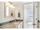 Bathroom featuring a vanity with a decorative-tile backsplash and a light-wood framed mirror at 101 S Gulfstream Ave # 14G, Sarasota, FL 34236