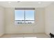 Bright bedroom featuring a large window with stunning water views, neutral walls, and tiled floors for easy maintenance at 101 S Gulfstream Ave # 14G, Sarasota, FL 34236