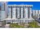 An exterior view of a condominium building showing balconies, the building's architectural elements, and surrounding landscaping at 101 S Gulfstream Ave # 14G, Sarasota, FL 34236