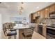 Open concept: Kitchen featuring granite counters, stainless appliances and seamless living room transition at 101 S Gulfstream Ave # 14G, Sarasota, FL 34236