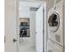 Laundry area next to the kitchen showcasing a stacked washer and dryer and tile floors at 101 S Gulfstream Ave # 14G, Sarasota, FL 34236