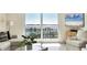 Bright living room with a marina view and white seating arrangement at 101 S Gulfstream Ave # 14G, Sarasota, FL 34236