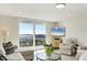 Bright living room features a balcony overlooking a harbor with city views, and neutral tile floor at 101 S Gulfstream Ave # 14G, Sarasota, FL 34236