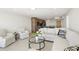 Open-concept living room with sleek tile floors and comfortable seating; the kitchen can be seen in the background at 101 S Gulfstream Ave # 14G, Sarasota, FL 34236