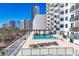 Stunning rooftop pool with views of city buildings, offering a luxurious and inviting amenity for residents at 101 S Gulfstream Ave # 14G, Sarasota, FL 34236