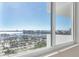 Captivating view of a harbor through a large window, showcasing boats, buildings and a sunny day at 101 S Gulfstream Ave # 14G, Sarasota, FL 34236