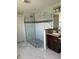 Bathroom featuring a glass-enclosed shower with modern tiles and granite countertop at 1056 Tampa Rd, Venice, FL 34293
