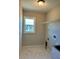 Efficient laundry room featuring a window, a shelf, and connections for a washer and dryer at 1056 Tampa Rd, Venice, FL 34293
