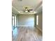 Bright and airy living room features wood-look flooring, ample natural light, and a tray ceiling at 1056 Tampa Rd, Venice, FL 34293