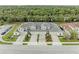 Birds eye view of a row of modern townhomes, highlighting their brick driveways and manicured lawns at 11607 Meadowgate Pl, Bradenton, FL 34211
