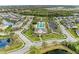 Stunning aerial view of a community clubhouse and pool with lush landscaping and surrounding homes at 11607 Meadowgate Pl, Bradenton, FL 34211