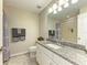 Well-lit bathroom features granite countertop, modern fixtures, and tiled shower at 11607 Meadowgate Pl, Bradenton, FL 34211