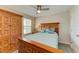 Cozy bedroom featuring a wooden bed frame and a window with natural light at 11607 Meadowgate Pl, Bradenton, FL 34211