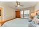 Bedroom with a wooden armoire and soft, natural light coming through the window at 11607 Meadowgate Pl, Bradenton, FL 34211