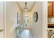 Inviting entryway with a decorative console table, charming light fixture, and stylish tiled flooring at 11607 Meadowgate Pl, Bradenton, FL 34211
