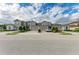 Townhomes featuring well maintained landscaping and paved driveways beneath a beautiful sky at 11607 Meadowgate Pl, Bradenton, FL 34211