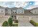 Attractive two-story townhome with an attached garage, a brick paver driveway and neatly landscaped front yard at 11607 Meadowgate Pl, Bradenton, FL 34211
