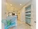 Hallway featuring nautical-themed decorations, tiled flooring, and a butterfly chair at 11607 Meadowgate Pl, Bradenton, FL 34211
