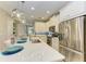 Stylish kitchen featuring white cabinets, stainless steel appliances, and a large island with seating at 11607 Meadowgate Pl, Bradenton, FL 34211