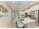 Bright kitchen featuring white cabinets, stainless steel appliances, and a large island with seating at 11607 Meadowgate Pl, Bradenton, FL 34211
