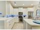 Kitchen featuring white cabinets, stainless steel appliances, backsplash, and an island with seating at 11607 Meadowgate Pl, Bradenton, FL 34211