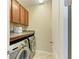 A bright and functional laundry room with washer, dryer, and storage cabinets at 11607 Meadowgate Pl, Bradenton, FL 34211