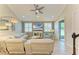 Cozy living room features tile floors, ample natural light and a ceiling fan at 11607 Meadowgate Pl, Bradenton, FL 34211