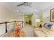 A cozy living room with plush seating, ceiling fan and well-lit with access to other areas at 11607 Meadowgate Pl, Bradenton, FL 34211