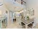 Open concept dining and living area featuring modern chandelier, tile floors and access to the kitchen at 11607 Meadowgate Pl, Bradenton, FL 34211