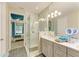The main bathroom features a glass shower and grey cabinets at 11607 Meadowgate Pl, Bradenton, FL 34211