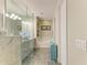 The main bathroom has a glass shower, soaking tub, and grey cabinets at 11607 Meadowgate Pl, Bradenton, FL 34211