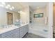 The main bathroom has a dual sink vanity, a soaking tub, and accent lighting at 11607 Meadowgate Pl, Bradenton, FL 34211