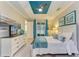 A bright main bedroom has a blue ceiling, white trim, and access to the lanai at 11607 Meadowgate Pl, Bradenton, FL 34211