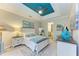 A coastal-themed main bedroom features a ceiling fan and access to the main bathroom at 11607 Meadowgate Pl, Bradenton, FL 34211