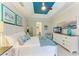 Bright main bedroom with white wood trim, tray ceiling and coastal decor at 11607 Meadowgate Pl, Bradenton, FL 34211