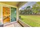 View from the screened patio to the inside living room and backyard view at 11607 Meadowgate Pl, Bradenton, FL 34211