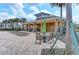 Relaxing poolside patio area featuring comfortable lounge chairs, tables, chairs, and sun umbrellas at 11607 Meadowgate Pl, Bradenton, FL 34211