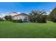 A well-maintained backyard with a lush lawn and privacy landscaping at 12014 Forest Park Cir, Bradenton, FL 34211