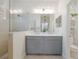Modern bathroom features double sinks, stone shower, and decorative shelves, creating a luxurious and functional space at 12014 Forest Park Cir, Bradenton, FL 34211