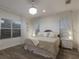 Serene bedroom featuring a decorative wall panel, sheer curtains, and wood flooring at 12014 Forest Park Cir, Bradenton, FL 34211