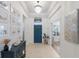 Bright foyer with tiled floors, chandelier and view of front door at 12014 Forest Park Cir, Bradenton, FL 34211