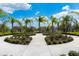 Beautiful front entrance featuring tropical landscaping, palm trees, and a well maintained walkway at 12014 Forest Park Cir, Bradenton, FL 34211