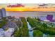 Scenic aerial view of a coastal city, with a vibrant sunset over the water, parks, theater, and city skyline at 1305 4Th St # 202P, Sarasota, FL 34236