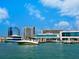 Picturesque harbor scene with various boats docked against a backdrop of city buildings under a bright, blue sky at 1305 4Th St # 202P, Sarasota, FL 34236